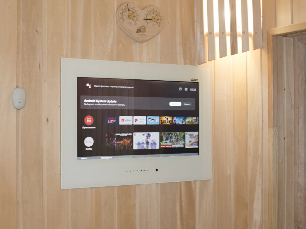 AVEL sauna TV on a light wood wall