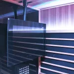 AVEL AVS240SM TV on a ceiling mount in a sauna with purple lighting