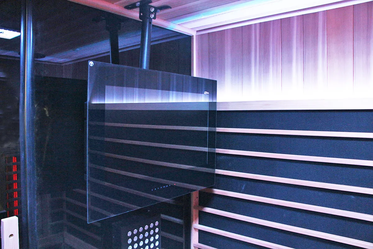 AVEL AVS240SM TV on a ceiling mount in a sauna with purple lighting