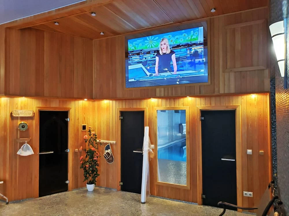 AVEL mirror TV in a wooden spa lounge
