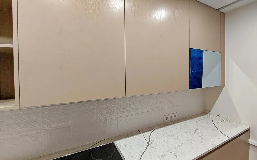 Kitchen cabinet door mirror TV in an upper cabinet