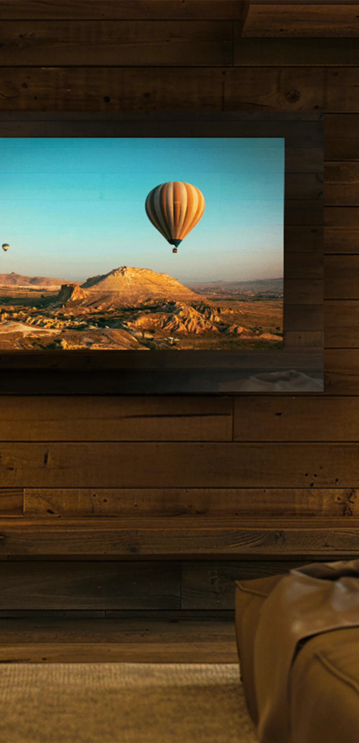 AVEL mirror TV on a rustic wood wall