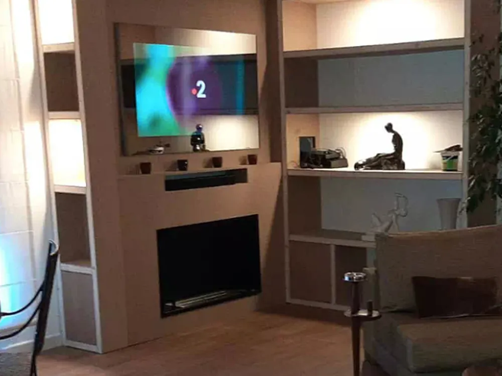 AVEL mirror TV above a fireplace in a living room
