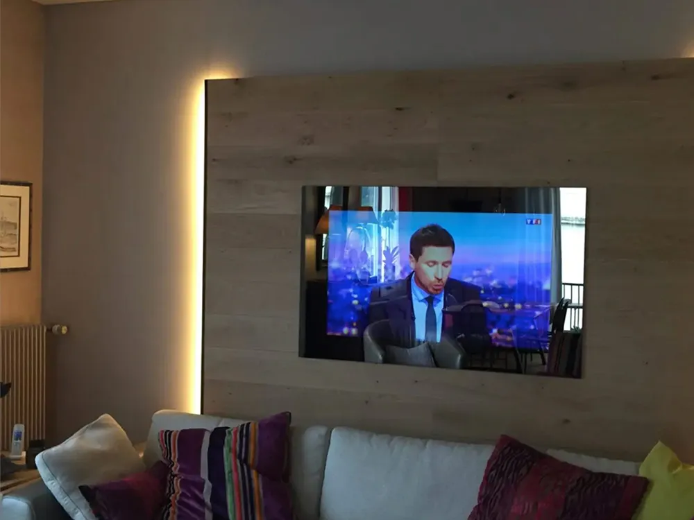 AVEL mirror TV in a wooden wall panel above a sofa