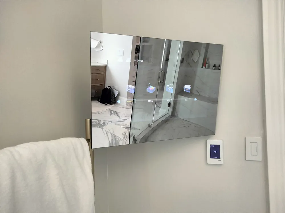 AVEL mirror TV on a bathroom wall