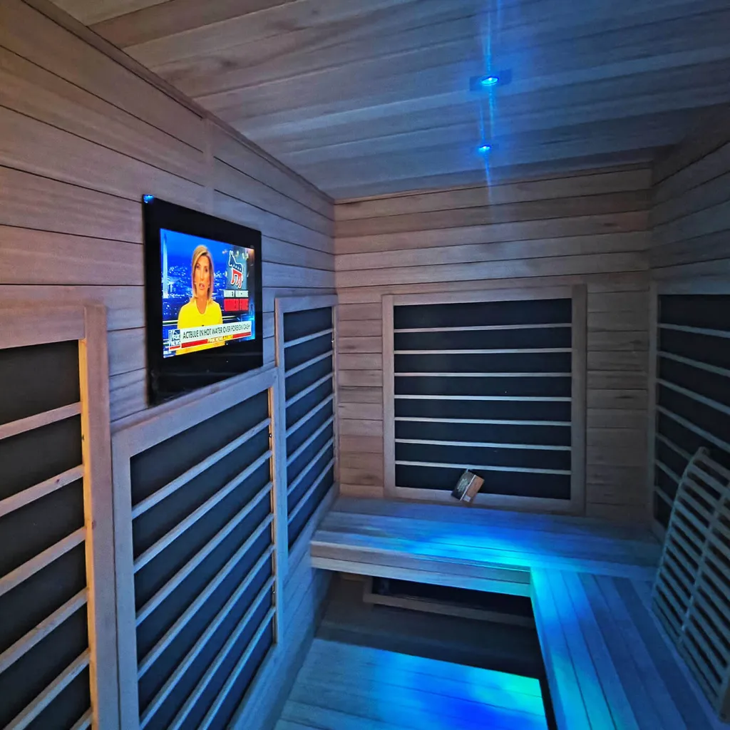 AVEL waterproof TV in an infrared sauna with blue lighting