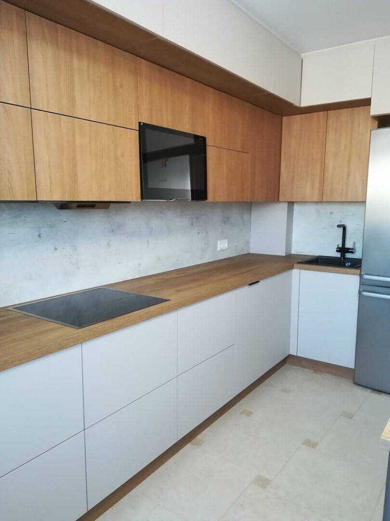 AVEL TV built into wood and white kitchen cabinets