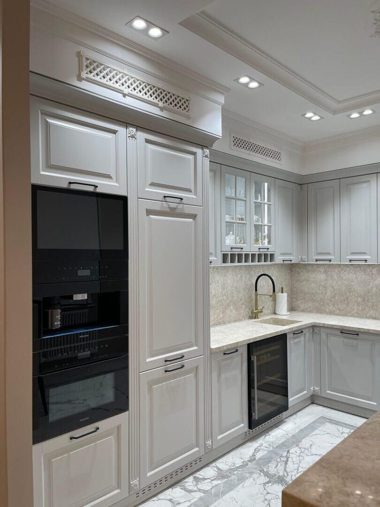 AVEL TV in a classic light grey kitchen above a coffee machine
