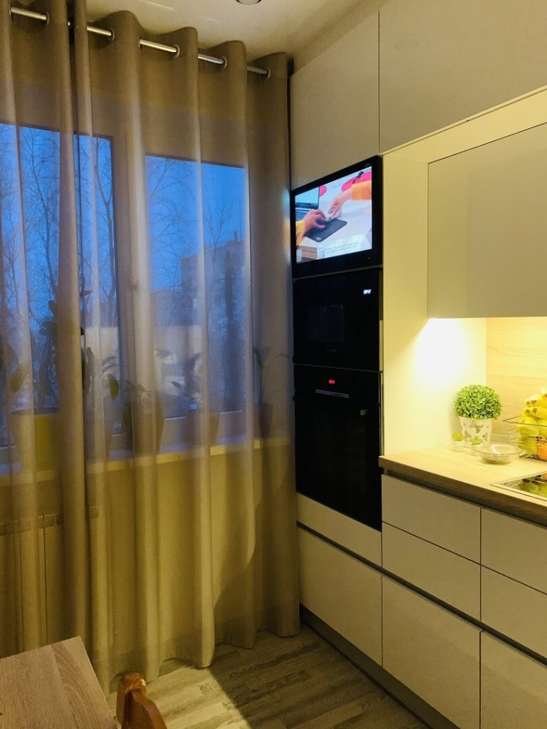 AVEL AVS240WS TV above an oven in a customer's kitchen