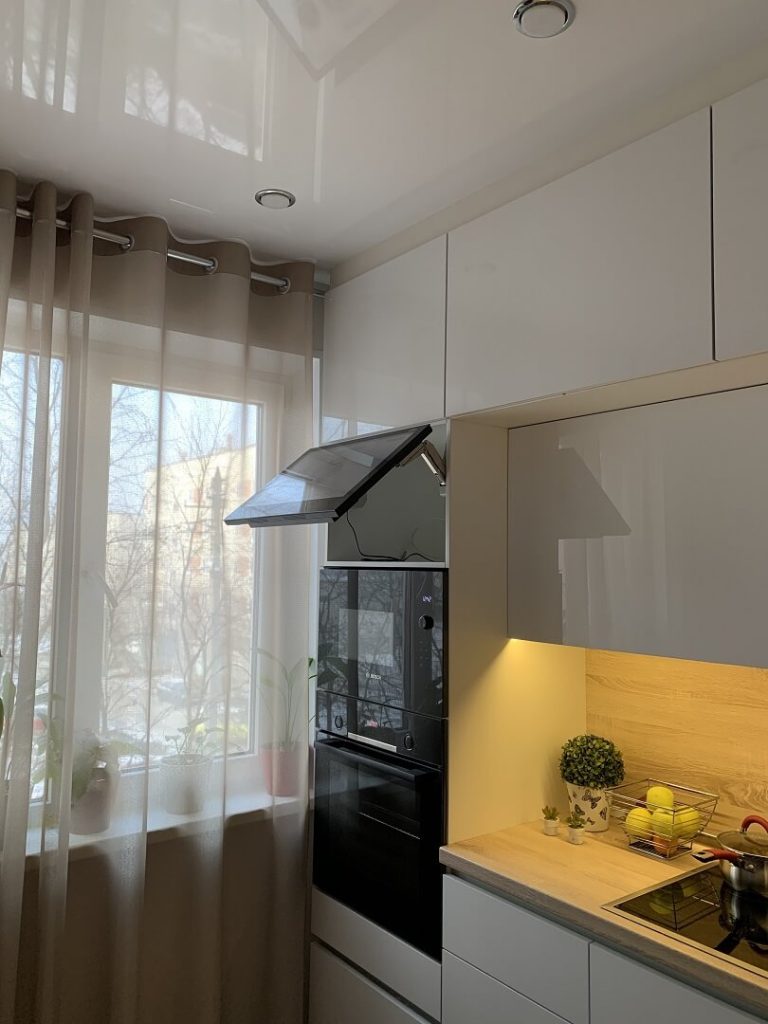 AVEL AVS240WS TV with the lift-up door open in a kitchen