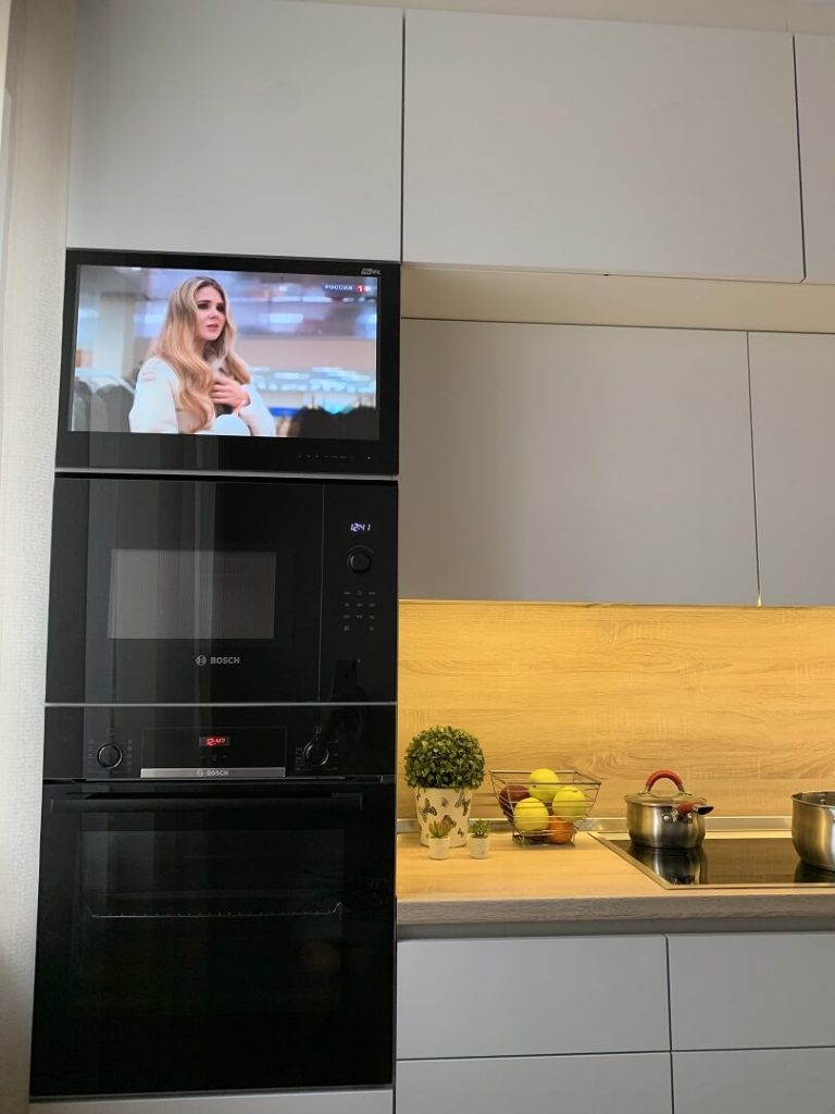 AVEL AVS240WS TV above a microwave and oven in a kitchen