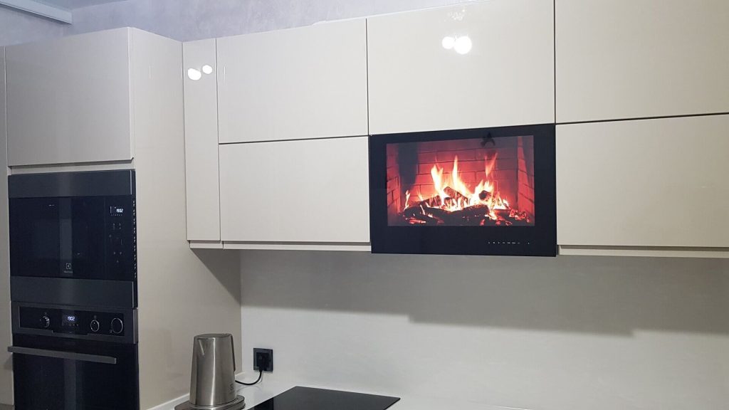 AVEL TV in a white kitchen cabinet showing a fireplace