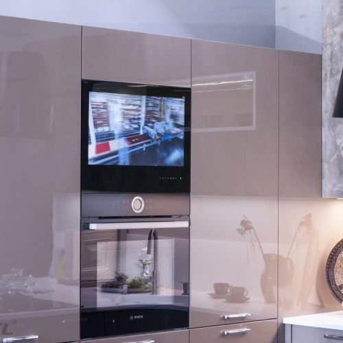 AVEL AVS240KS kitchen TV above an oven in a beige kitchen