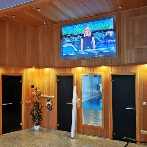 AVEL mirror TV in a wooden spa lounge